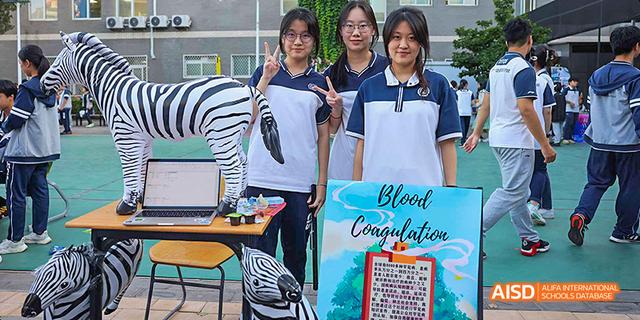 A student showing a certificate of congratulations in a classroom at Beijing 21st Century School.