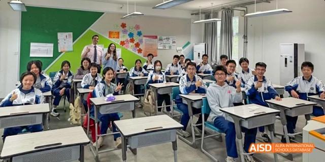 Two students are seated at a desk, looking at a laptop at Beijing 101 Middle School.