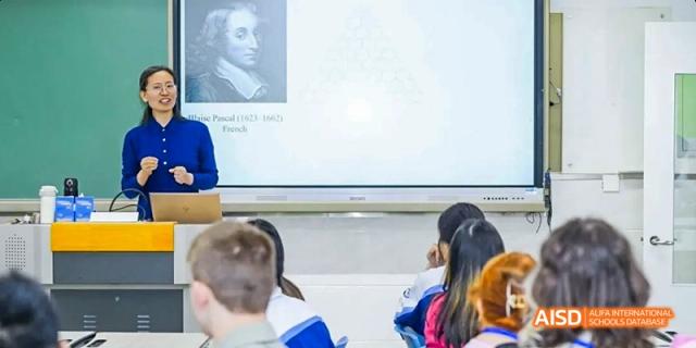 Two students are looking at something on a smart board in a classroom at Beijing 101 Middle School.