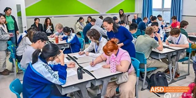 A group of students is seated at a table, working on a project at Beijing 101 Middle School.