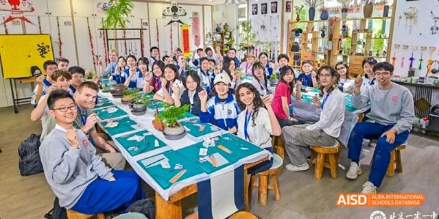 A group of students are seated around a long table in a library at Beijing 101 Middle School.