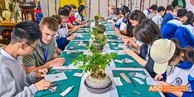 A group of students are seated at a table, working on a project at Beijing 101 Middle School.