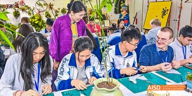 Two students are looking at a plant on a table at Beijing 101 Middle School.