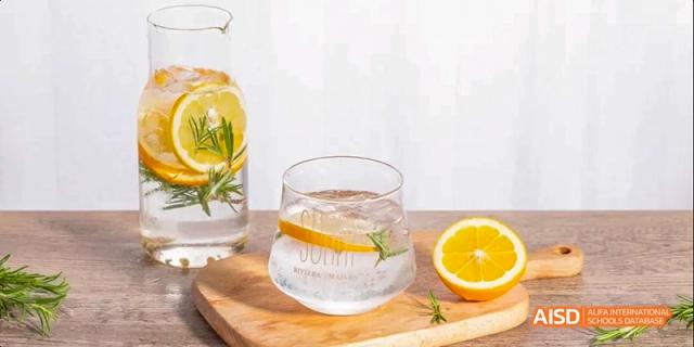 A clear glass dispenser is filled with water and slices of fruit at Beijing 101 Middle School.