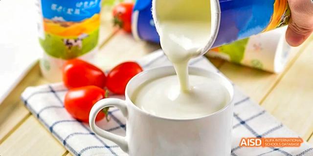 A glass of milk is being poured into a bowl of food at Beijing 101 Middle School.