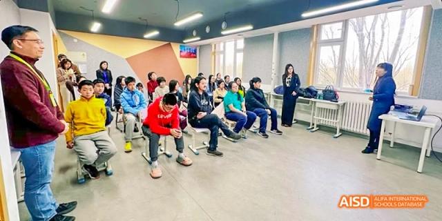 A photo showing a group of students sitting in a circle in a classroom, at Beijing Enlighten School.