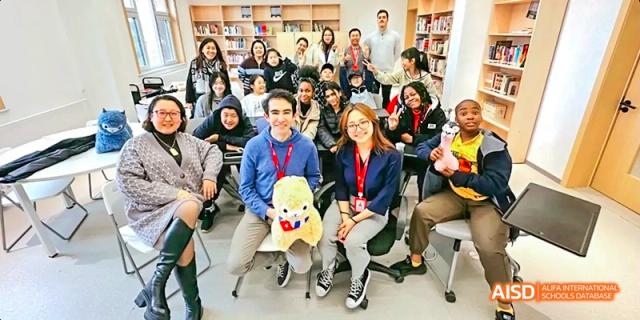 A photo showing a group of people sitting in a library, at Beijing Enlighten School.