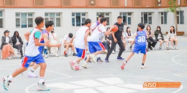 A photo showing a group of students playing basketball, at Beijing Enlighten School.