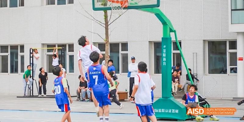 A photo showing students playing basketball, at Beijing Enlighten School.