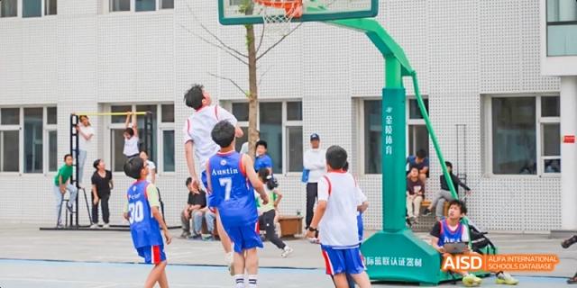 A photo showing students playing basketball, at Beijing Enlighten School.