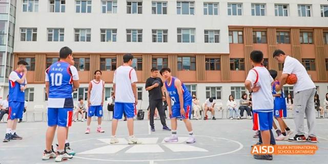 A photo showing a group of students playing basketball, at Beijing Enlighten School.