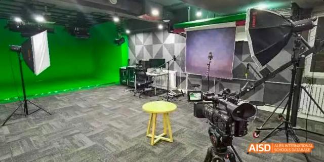 A photo showing a green screen studio with cameras and musical instruments, at Beijing Enlighten School.