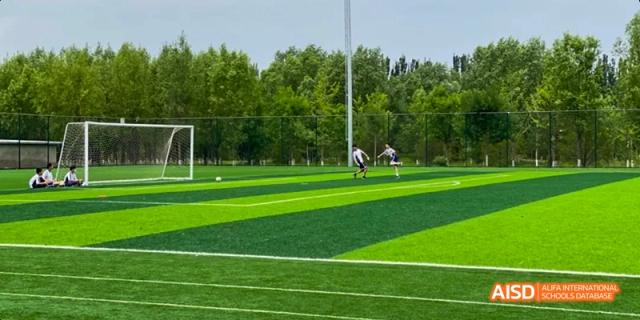 A photo showing a football field, at Beijing Enlighten School.