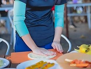 A photo showing a person kneading dough, at Beijing Enlighten School.