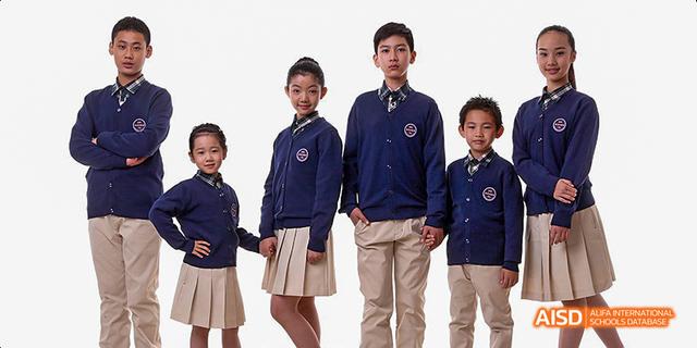 Students from Beijing Haidian Foreign Language Academy posing in their navy blue uniforms.
