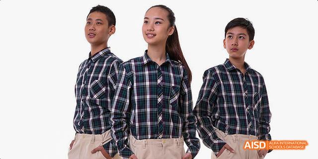 Students from Beijing Haidian Foreign Language Academy in plaid shirts posing together.