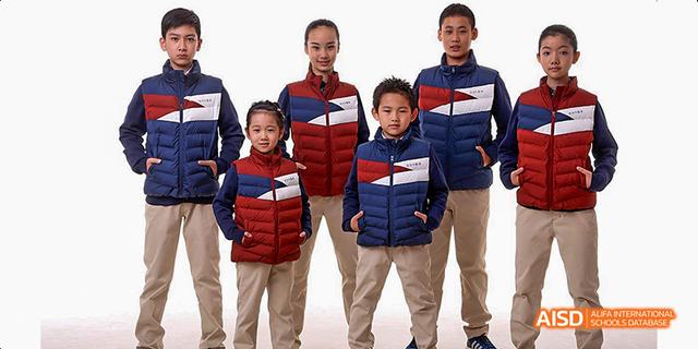 Students from Beijing Haidian Foreign Language Academy posing in red and blue puffer vests.