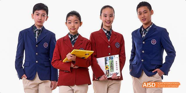 A group of students from Beijing Haidian Foreign Language Academy posing for a portrait with one student holding books.