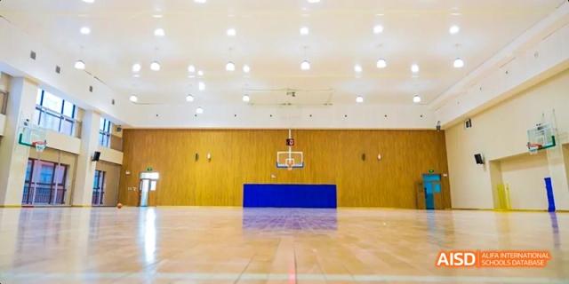 An empty indoor basketball court at Beijing Haidian Foreign Language Academy.