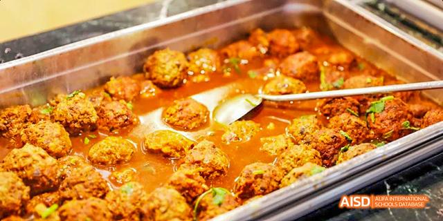 A close-up of meatballs in a sauce from the cafeteria of Beijing Haidian Foreign Language Academy.