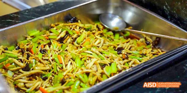 A close-up of stir-fried vegetables and noodles from the cafeteria of Beijing Haidian Foreign Language Academy.