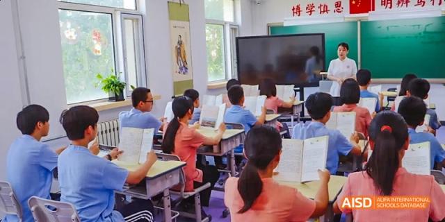 Students working at computers in a classroom at Beijing Hui Xian School.