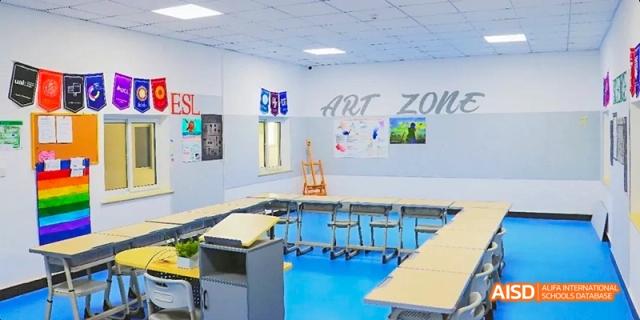 A brightly lit art classroom with a sign that says "ART ZONE" at Beijing Hui Xian School.