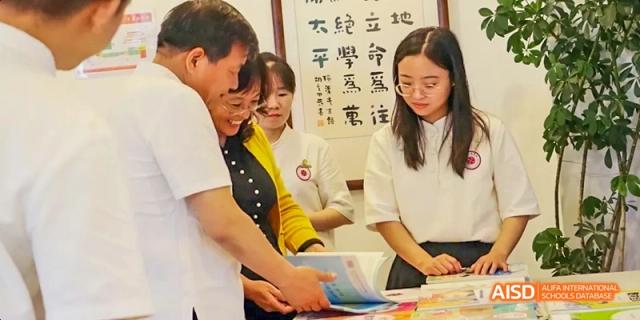 An adult helping a student prepare food at Beijing Hui Xian School.