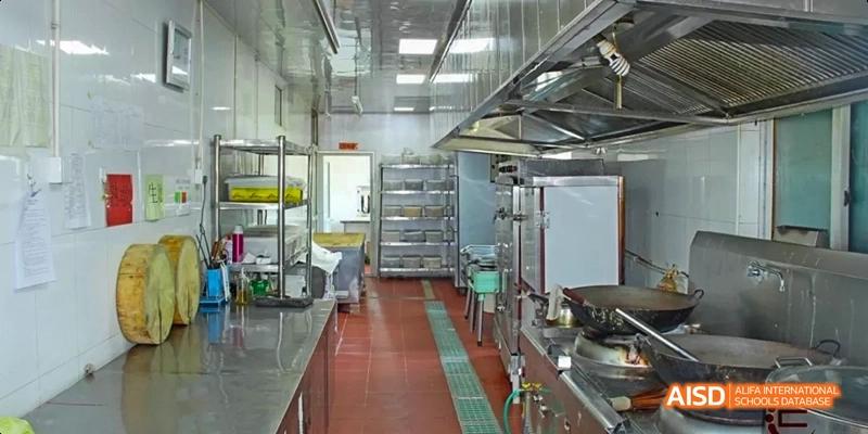 A clean, stainless-steel kitchen or food preparation area at Beijing Hui Xian School.