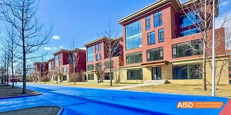 A modern residential or dormitory building with red accents at Beijing Hui Xian School.