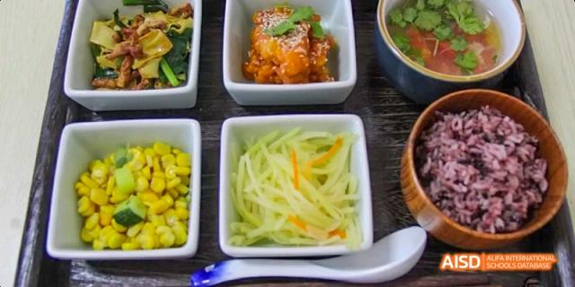 A collection of different dishes, including a stir-fry and other vegetables, at Beijing Hui Xian School.
