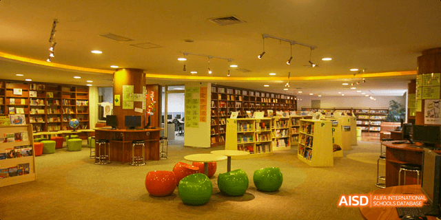 A wide shot of the library or a study hall at Beijing Huijia Private School, with tables and bookshelves.