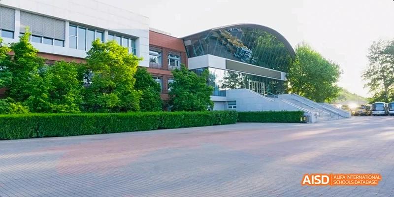 A photo of a building and grounds at Beijing Huijia Private School.