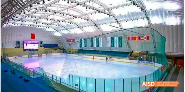 An interior shot of a large ice rink at Beijing Huijia Private School.