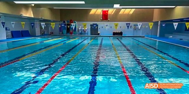 A swimming pool at Beijing Huijia Private School, with lanes ready for a race.