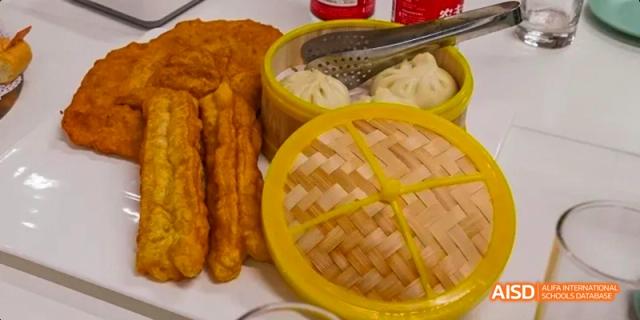 Close-up of various delicious fried foods and dim sum from the canteen at Beijing Huijia Private School.