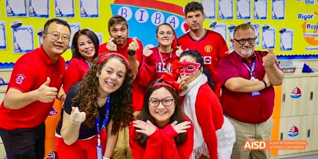 A group of students smiling and posing for a photo at a school event at Beijing International Bilingual Academy.