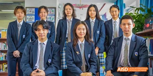A group of students in school uniforms and ties posing for a group photo at Beijing International Bilingual Academy.