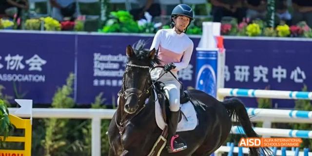 An athlete on horseback competing in an equestrian event at Beijing International Bilingual Academy.