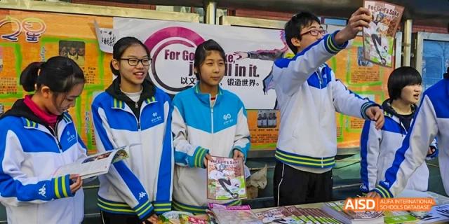 Students from Beijing National Day School International Department at a school event booth.