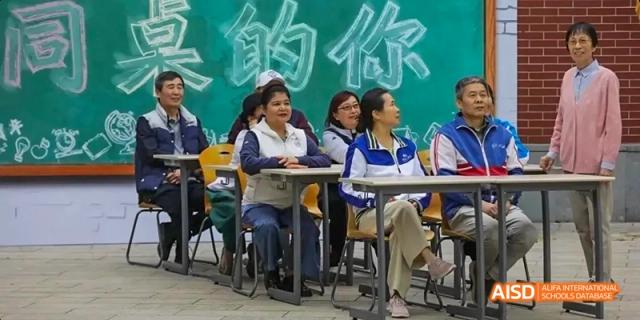 Students from Beijing National Day School International Department seated at desks, looking toward the front of the classroom.