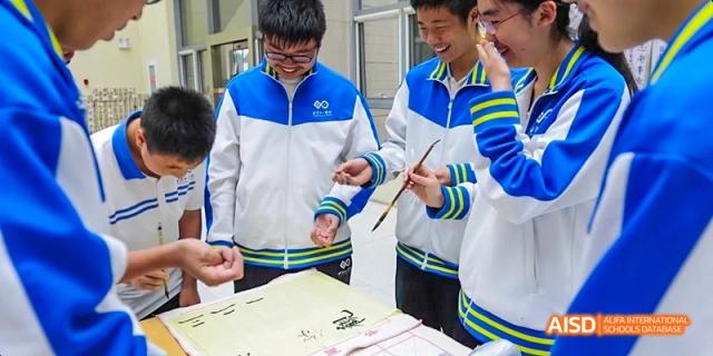 Students from Beijing National Day School International Department collaborating on a project in a classroom.