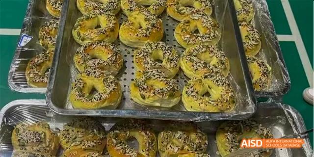 Baked goods with sesame seeds, possibly made by students from Beijing National Day School International Department.