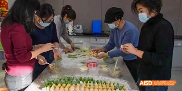 Students from Beijing National Day School International Department learning to prepare dumplings in a cooking class.