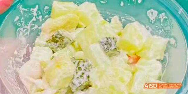 A potato or fruit salad dish served at an event for Beijing National Day School International Department.