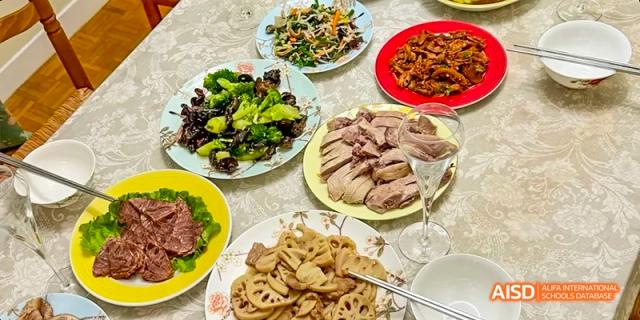 A spread of different Chinese dishes, possibly from a school event at Beijing National Day School International Department.