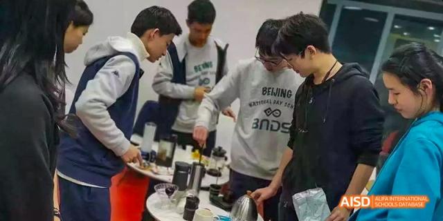 Students from Beijing National Day School International Department working on a science or engineering project together.