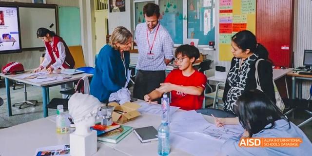 A photo showing students in a classroom doing a medical experiment, at Beijing Royal School.