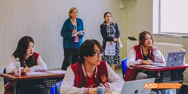 A photo showing students in a classroom with a teacher, at Beijing Royal School.