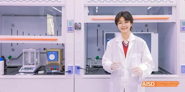 A photo showing a male student in a lab, at Beijing Royal School.